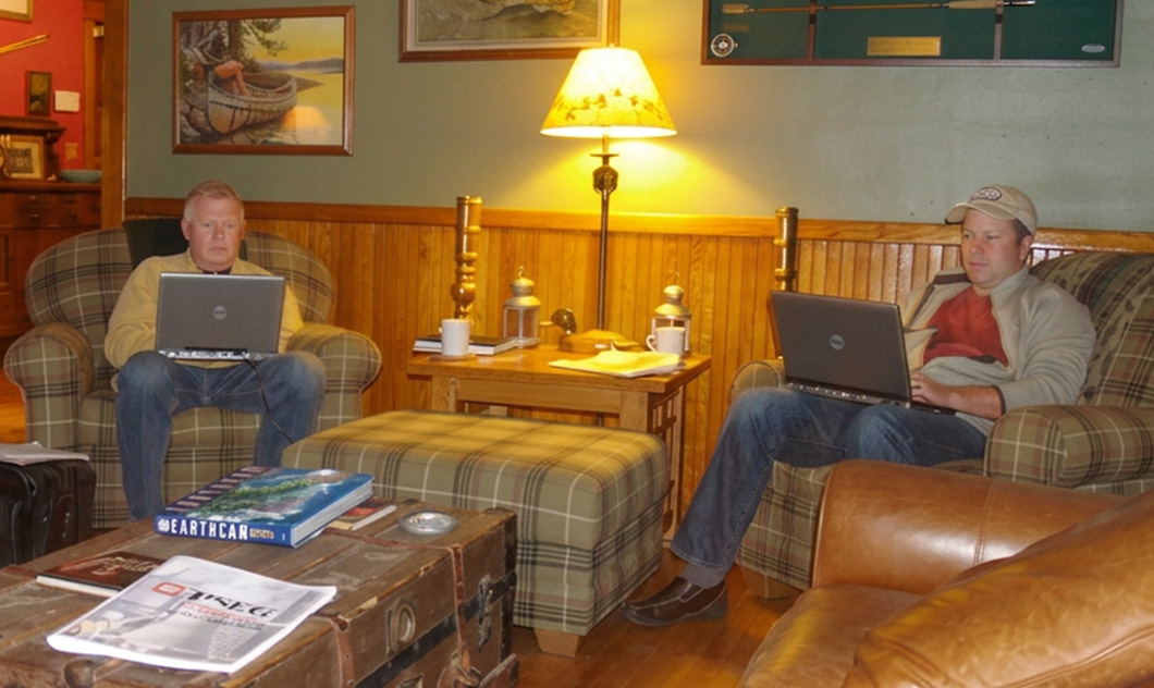 HexArmor’s founders sitting in a living room with laptops in the early years of the company.
