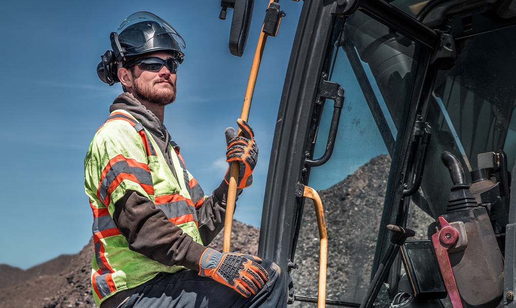 Construction worker wearing HexArmor’s high-performance safety gloves, eyewear, and helmet.