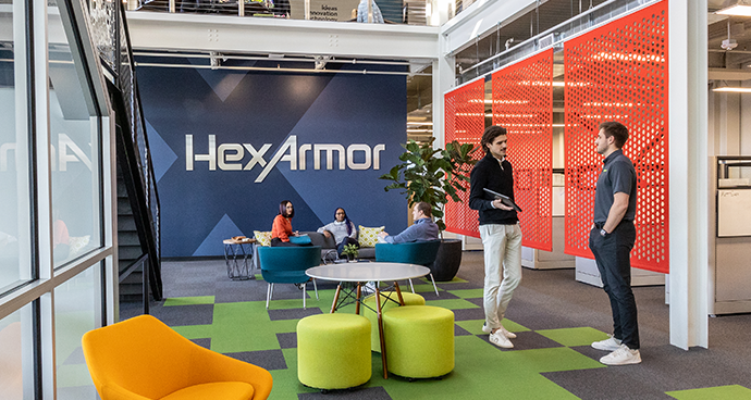 HexArmor employees collaborating in an open office space.