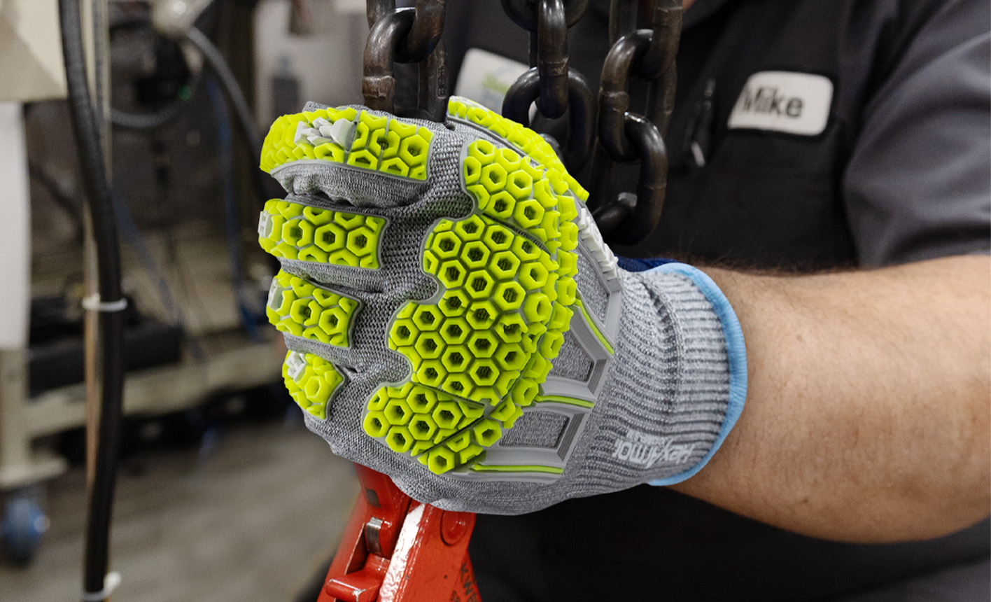 Worker wearing the Helix 3013IMP knit safety glove working with chains.