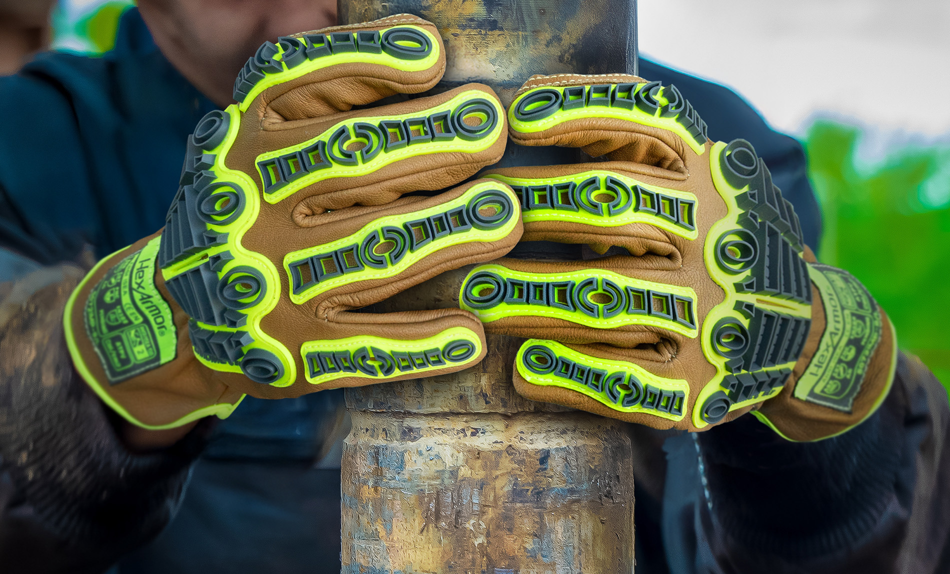 Oil rig worker wearing the 5071IMP leather work gloves while gripping an oil pipe.