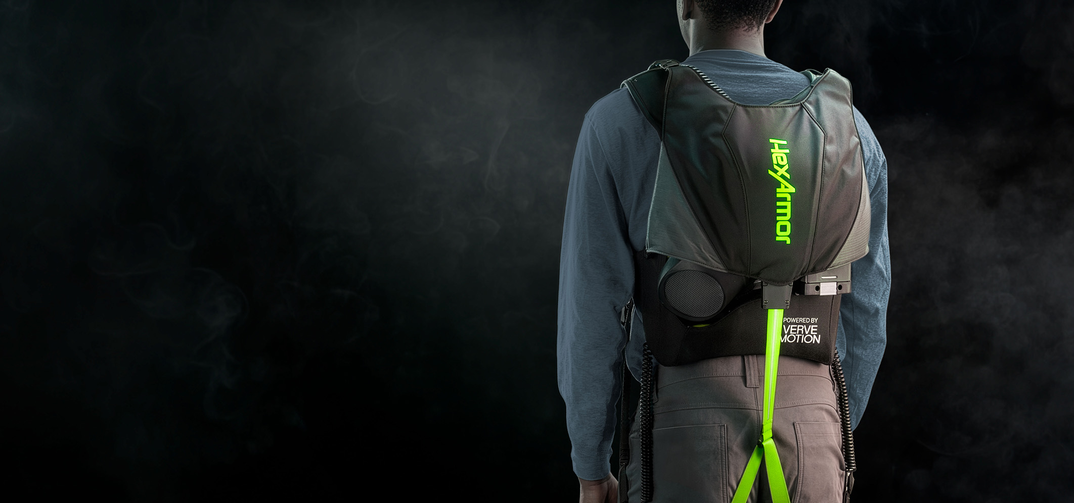 Worker seen from behind wearing the HexArmor SafeLift exosuit, powered by Verve Motion