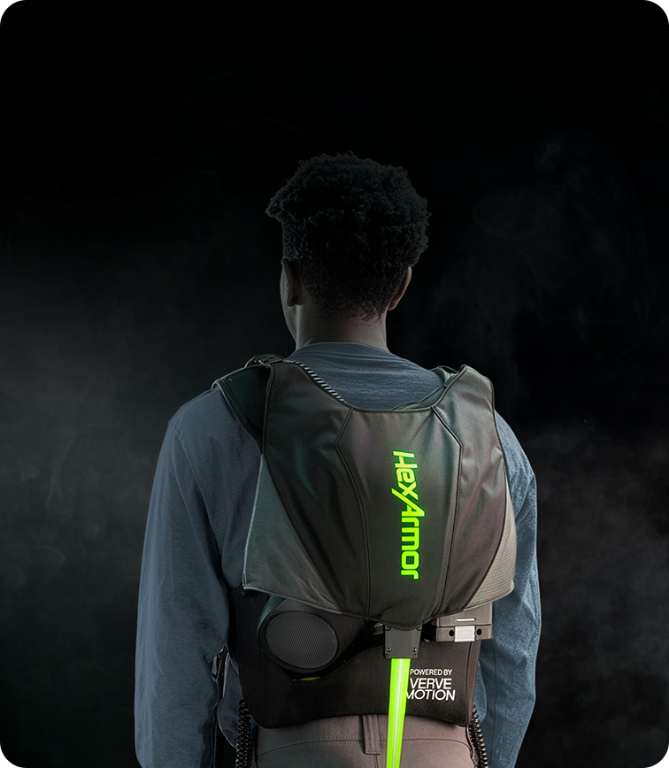 Worker seen from behind wearing the HexArmor SafeLift exosuit, powered by Verve Motion