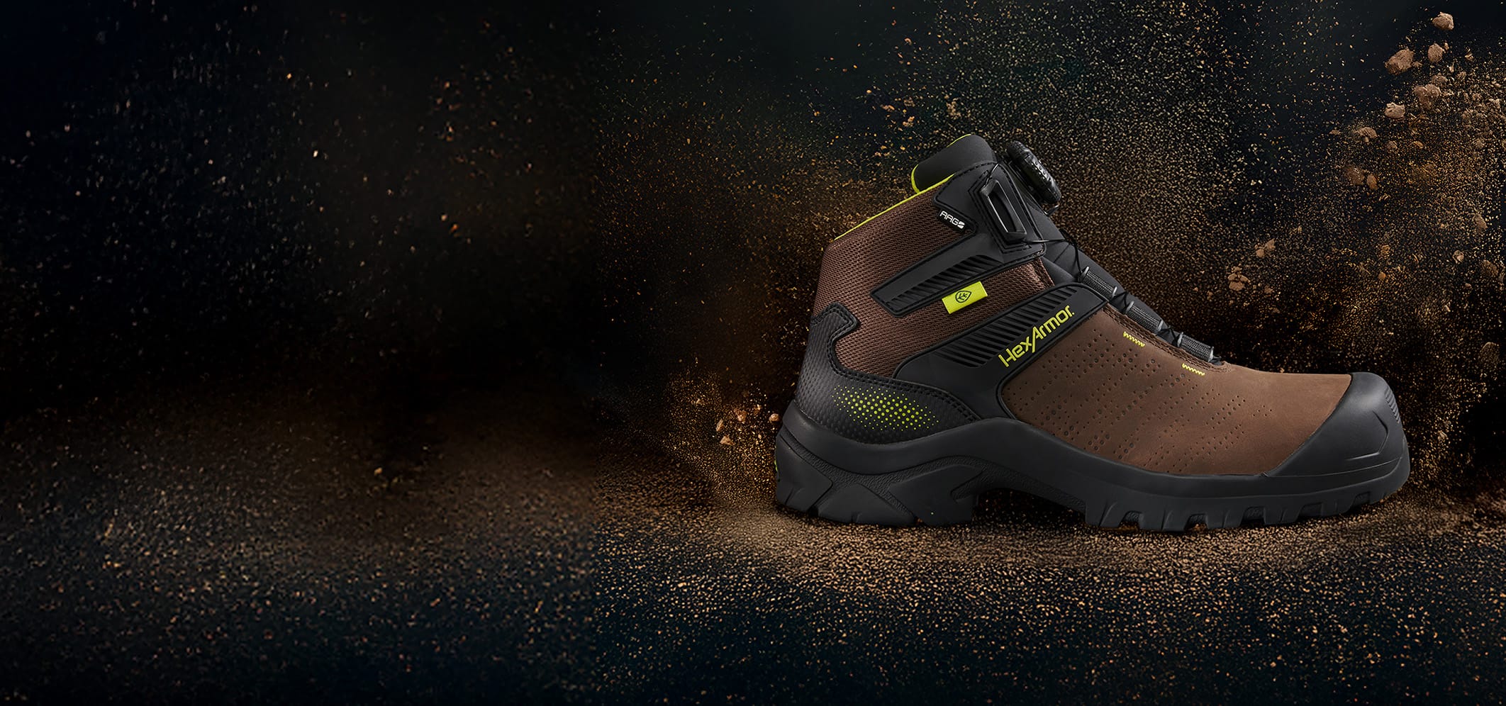 Profile of brown Xbase Boa safety boot with dirt flying repelling off boot