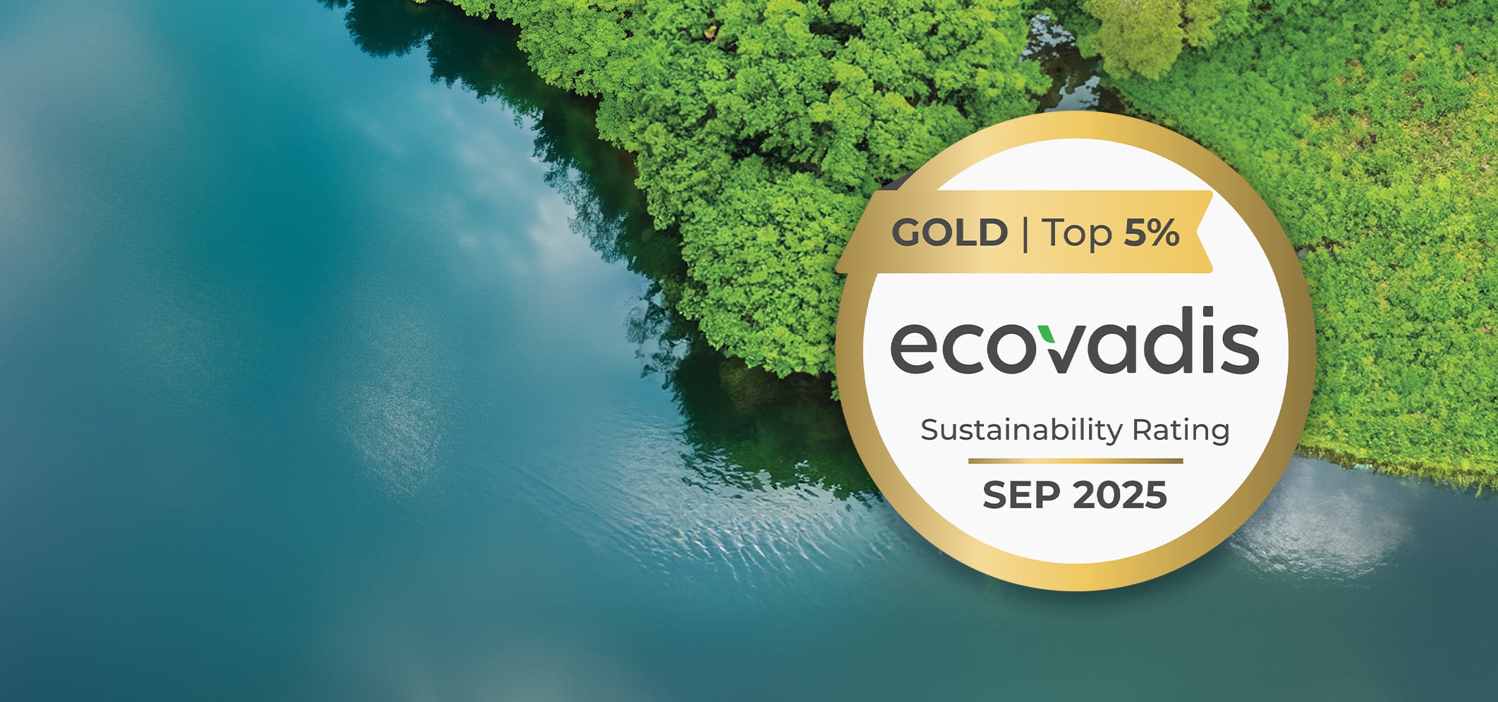 Aerial view of a blue-green river bordered by green trees. A gold badge on the right reads "Gold | Top 5% Ecovadis Sustainability Rating, Sep 2025."