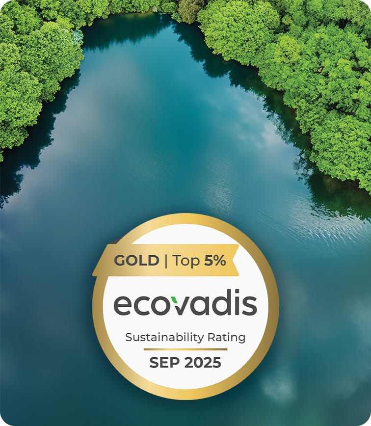 Aerial view of a blue-green river bordered by green trees. A gold badge on the right reads "Gold | Top 5% Ecovadis Sustainability Rating, Sep 2025."